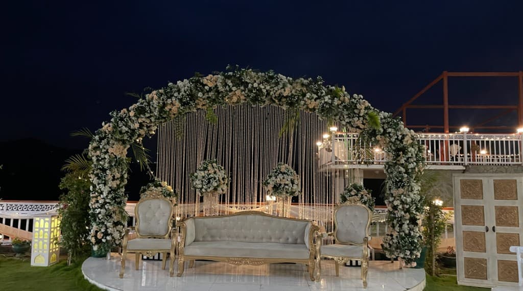 Night-time nikah stage with crystal curtain and peach floral arch